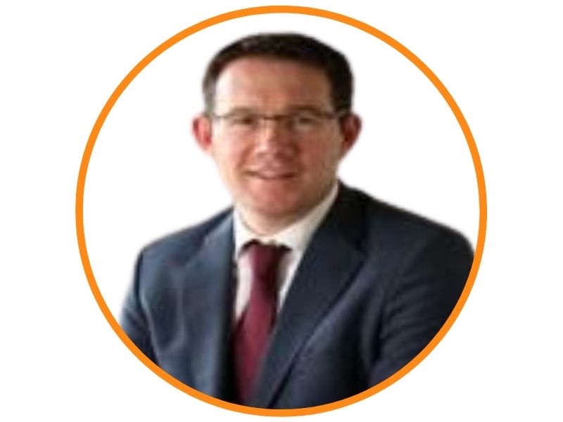 Joseph Higgins Guinness Storehouse Man with brown hair wearing glasses and suit and tie smiling