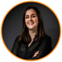 Brown haired woman smiling with her hands crossed